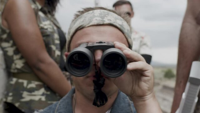 Short man looking through binoculars - close up