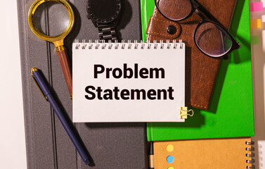 PROBLEM STATEMENT text on notebook with pen on a chart background.