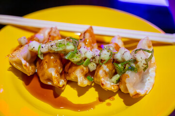 Tasty asian food, homemade deep fried chicken gyoza dumplings close up in Japanese bar