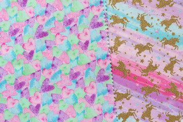 two pieces of material with prints featuring hearts and unicorns