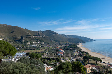View on sandy beach from hilly medieval small touristic coastal town Sperlonga and sea shore, Latina, Italy
