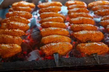 Turkish mixed grill meat, chicken wings, lamb, beef shashlik, kebab cooking on charcoal grill in restaurant