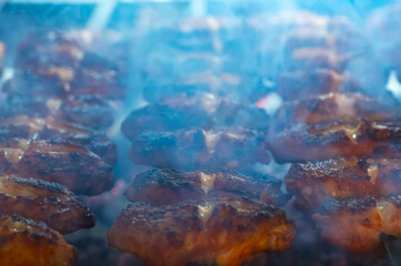 Turkish mixed grill meat, chicken wings, lamb, beef shashlik, kebab cooking on charcoal grill in restaurant