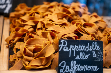 Italian food, dried handmade colorful pasta pappardelle with saffron, ready to cook, Milan,...