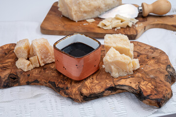 Tasting of 24 and 48 months aged Italian parmesan hard cheese from Parmigiano-Reggiano, Italy and balsamico vinegar from Modena