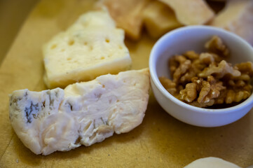 Cheese tasting, piece of italian blue cheeses gorgonzola dolce and picante with blue mold from north of Italy close up