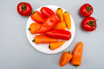 Fresh red, orange, and yellow sweet bell paprika close up