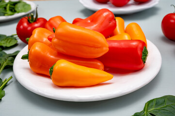 Fresh red, orange, and yellow sweet bell paprika close up