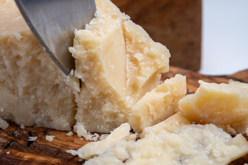 Traditional italian food - 22 months aged in caves Italian parmesan hard cheese from Parmigiano-Reggiano, Italy