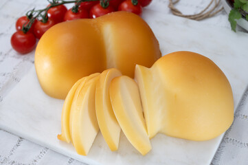 Cheese collection, Italian cheese scamorza, caciocavallo, provolone made from cow milk in South Italy yellow smoked cheese