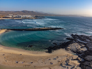 West coast of Fuerteventura island. Winter sea and sun vacation in El Cotillo touristic village, Canary islands, Spain. White sandy beach La Concha..