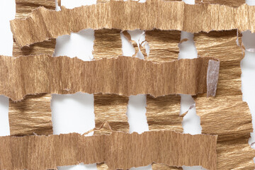 torn metallic gold finish crepe paper with ragged edges on blank paper
