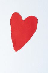 Naklejka na ściany i meble somewhat stretched red paper heart with decorative torn edge isolated on blank paper
