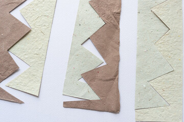 set of paper shapes with saw-tooth or zig zag edges on blank paper with texture