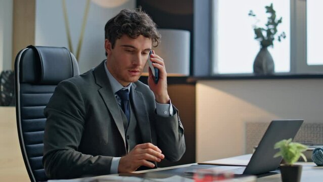 Typing boss answering call at luxury office closeup. Happy businessman talking