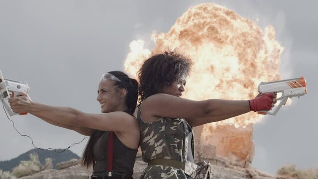 Cinematic shot of two women with toy guns and epic explosion