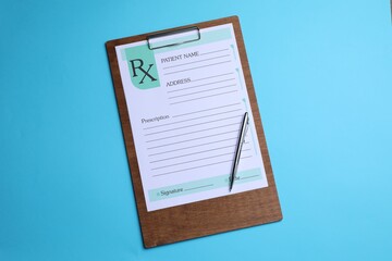 Clipboard with medical prescription form and pen on light blue background, top view