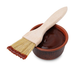 Marinade in bowl and basting brush isolated on white