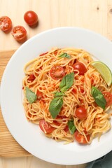 Vegetarian meal. Tasty pasta with fresh tomatoes and basil on wooden table, flat lay