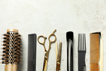 Professional hair dresser tools on grey textured background, flat lay. Space for text - obrazy, fototapety, plakaty