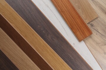Different samples of wooden flooring as background, top view