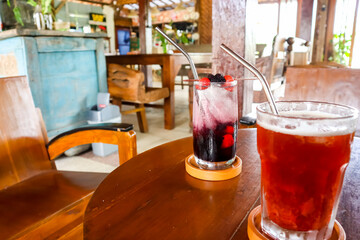 Refreshing summer drink, Berry mojito cocktail and juice with javanese vibes background. Enjoying...