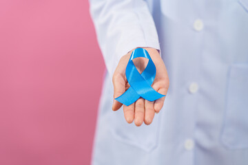 Prostate cancer awareness. Close up medical doctor holding ribbon over pink background isolated. oncology, prostate cancer awareness month, world diabetes day.