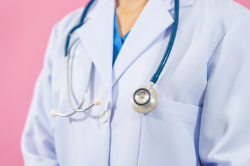 Close up female medical doctor isolated on pink background.