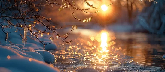 Fotobehang Breathtaking Bokeh Sunset Illuminates SnowCovered Riverbank with Icicles © Sittichok