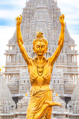 Statue of Nilkanth Varni with Akshardham Mahamandir temple in the back