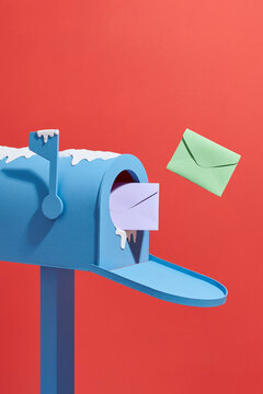 Winter Post box with the letters envelops flying out