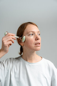A woman does a facial massage