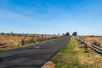 Fototapeta premium A two-lane road in the Gettysburg National Military Park in Gettysburg, Pennsylvania, USA on a sunny winter day
