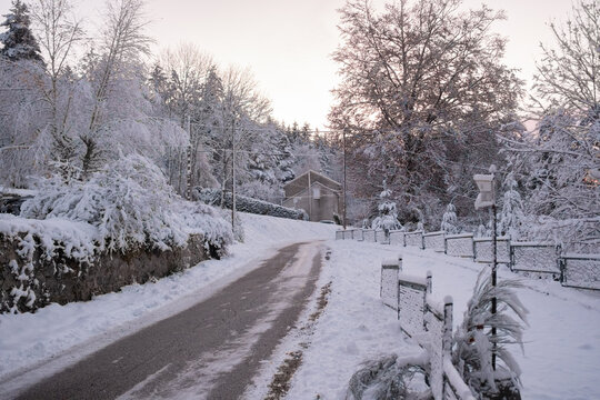  ice covered road going through a snowy French village 