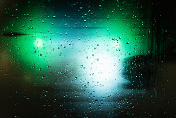 Green and blue lights on a rainy night