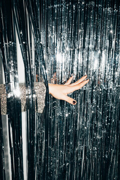 Woman's hand and string drape