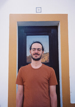 Film photography of positive young man standing with closed eyes