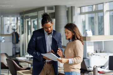Business executives planning over report at office