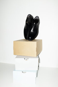 Classic black lace shoes and shoe boxes with hard direct flashlight