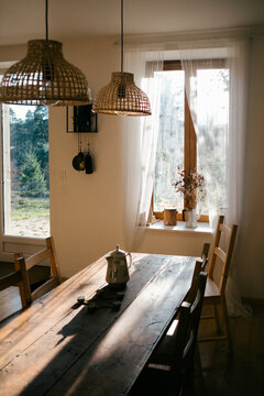 table and French windows with morning light and dried bouquet