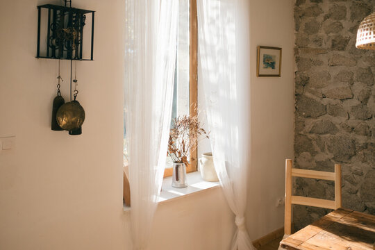 French windows with morning light and dried bouquet