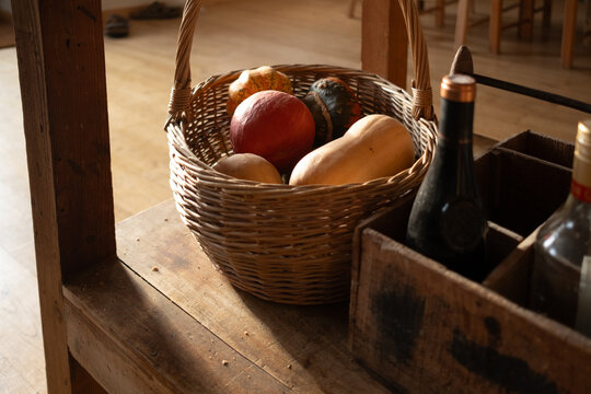  basket with pumpkins & gourds on a table in rustic table