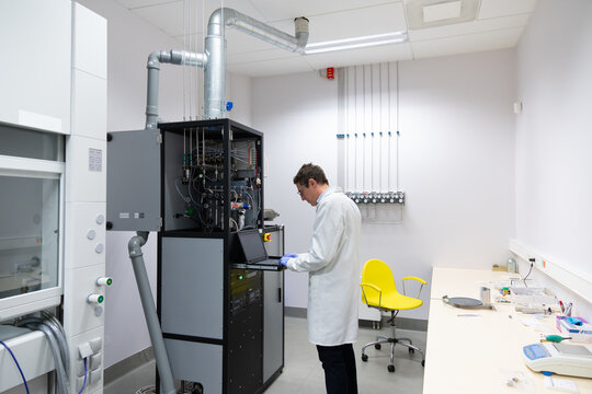 Researcher Using Atomic Layer Deposition Device.