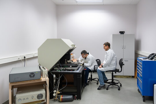 Researchers Working With Atomic Force Microscope.