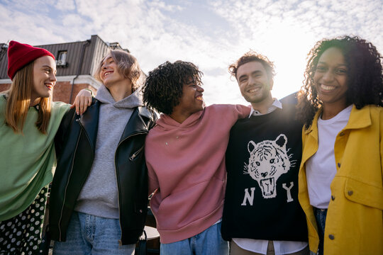 A Group Of Five Friends Hugging In The City