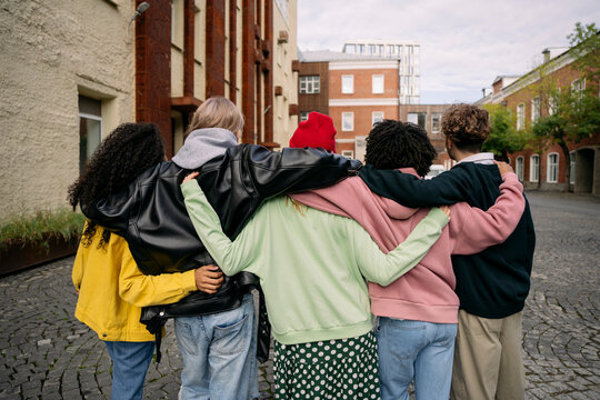 Five friends embrace outdoors