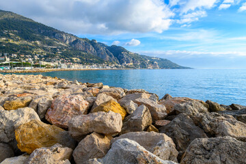 Fototapeta na wymiar View from the plage des Sablettes beach at Menton, France, looking towards the Italian border and the Garavan port district and town of Ventimiglia, Italy.