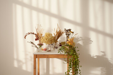 The table with the plants in the sunny room