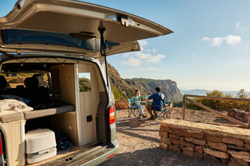 Couple of travelers enjoying picnic in countryside