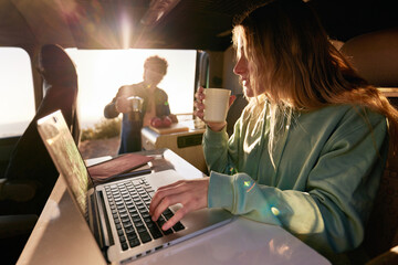Female freelancer working in camper van